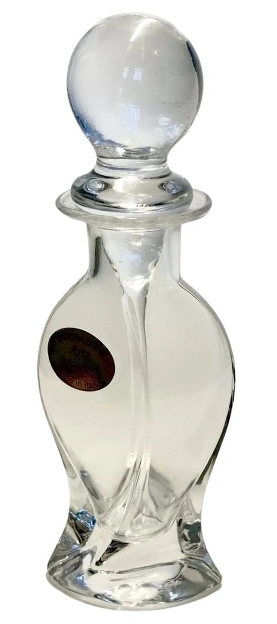 A clear glass bottle with a brown seal on it.