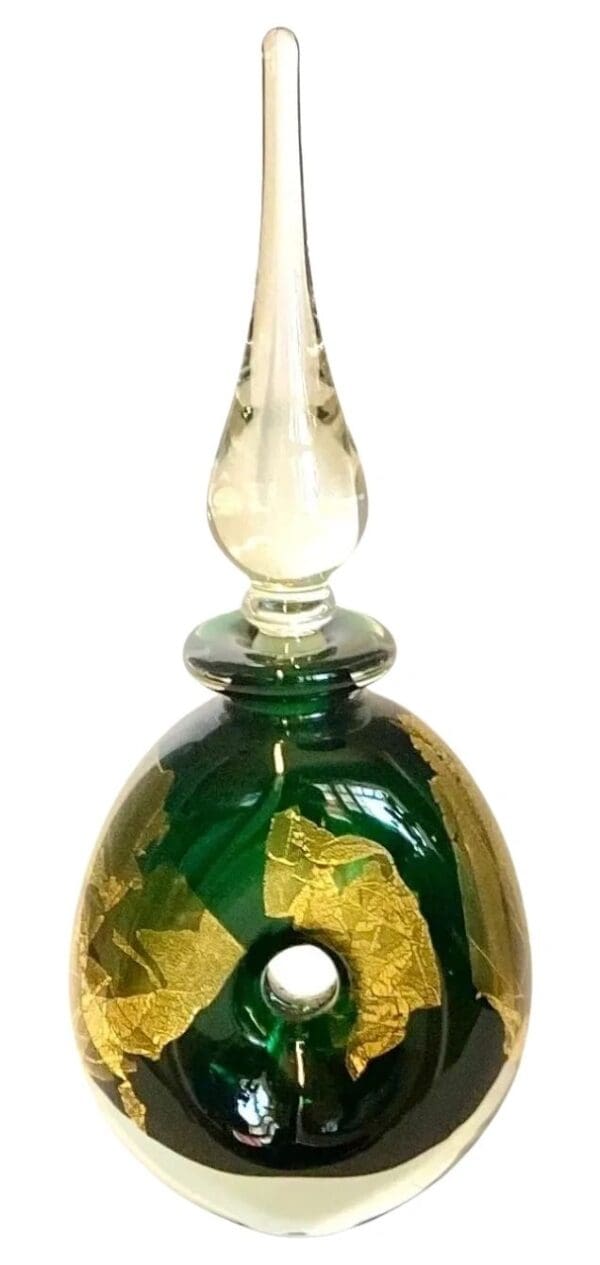 A green and gold glass bottle with a clear top.