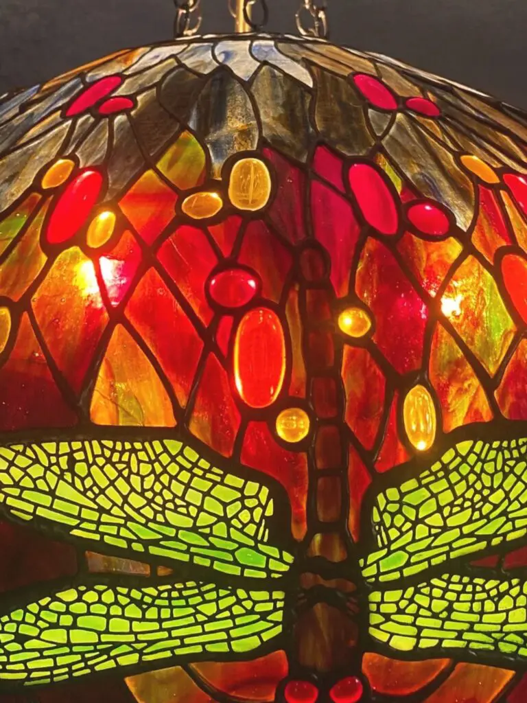 A close up of the bottom part of a stained glass lamp.