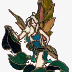 A stained glass fairy sitting on leaves.