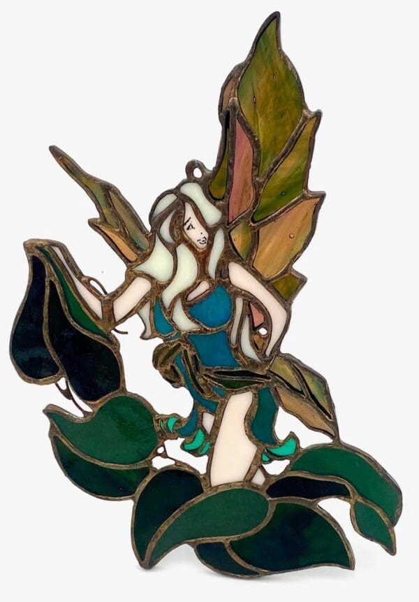 A stained glass fairy sitting on leaves.