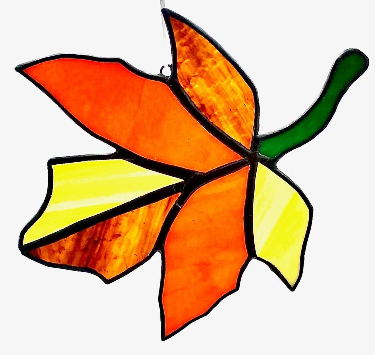 A stained glass leaf is shown in this picture.