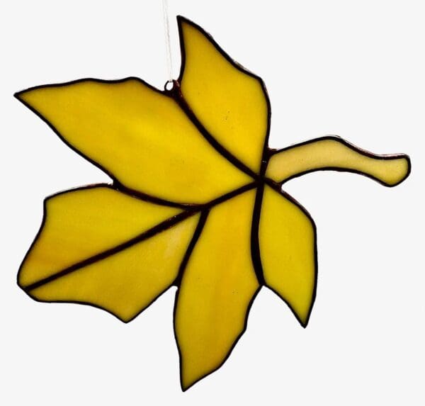 A stained glass leaf is shown in yellow.